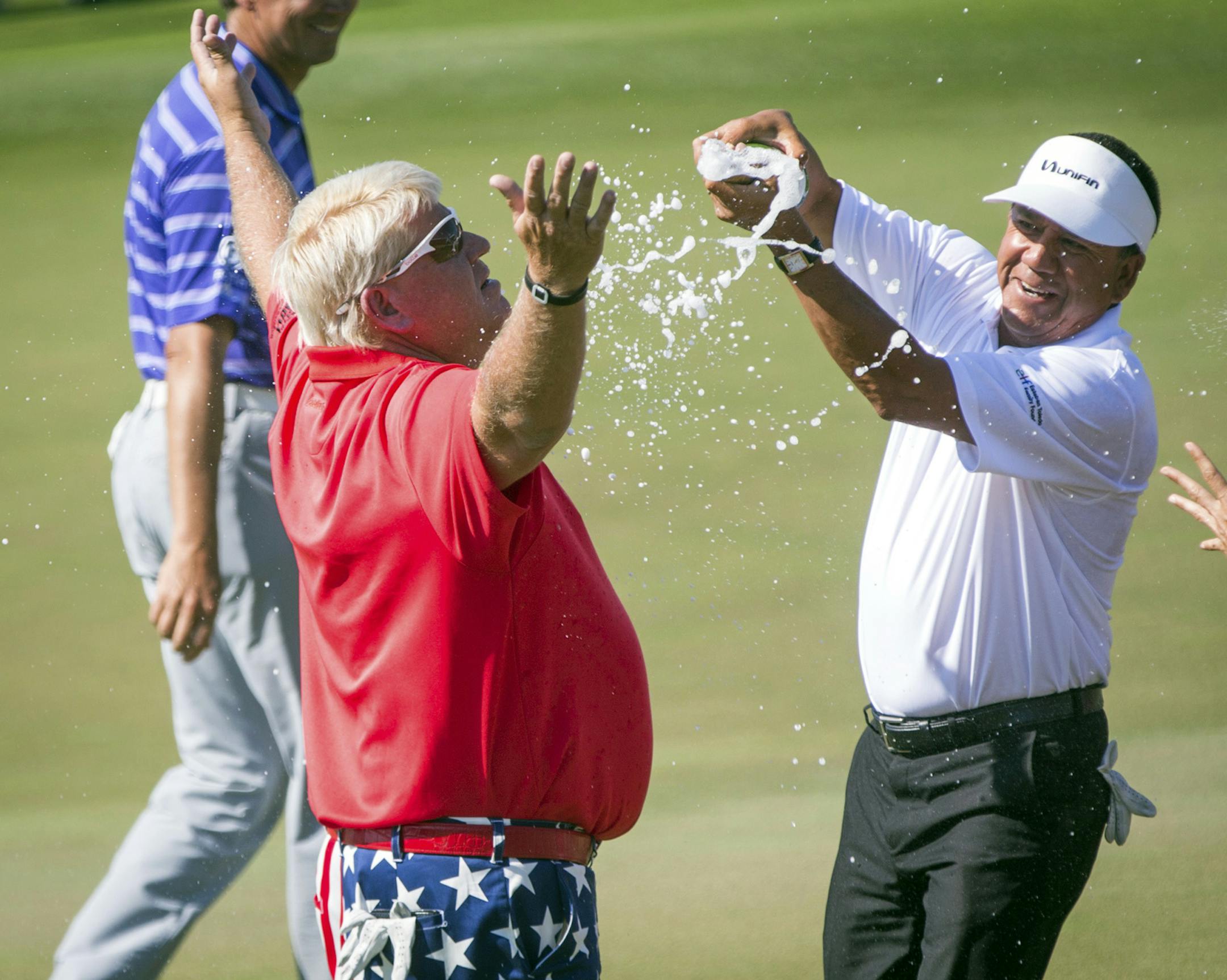 John Daly is doused after winning the Insperity Invitational golf tournament on Sunday, May 7, 2017, in The Woodlands, Texas. (Michael Minasi/Houston Chronicle via AP)