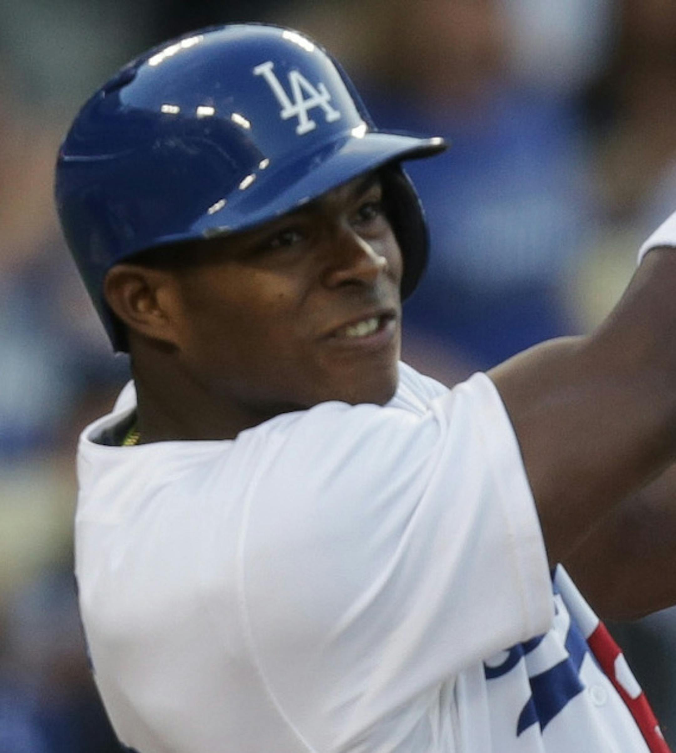 Los Angeles Dodgers' Yasiel Puig follows through for a double during the first inning of their baseball game against the San Diego Padres, Tuesday, June 4, 2013, in Los Angeles. (AP Photo/Jason Redmond) ORG XMIT: LAD104