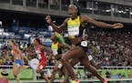Jamaica's Elaine Thompson celebrates after winning gold in the women's 100-meter final during the athletics competitions of the 2016 Summer Olympics a