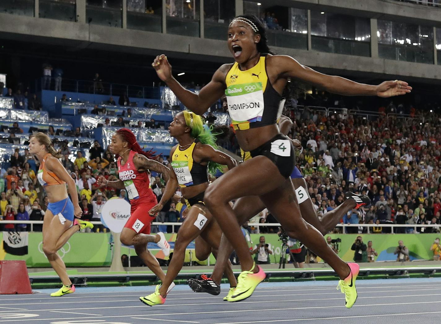 Jamaica's Elaine Thompson celebrates after winning gold in the women's 100-meter final during the athletics competitions of the 2016 Summer Olympics at the Olympic stadium in Rio de Janeiro, Brazil, Saturday, Aug. 13, 2016. (AP Photo/Matt Slocum)