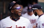 Injured Twins third baseman Miguel Sano smiled from the dugout on Opening Day. He is set to report to Fort Myers this week to enhance his rehab from a