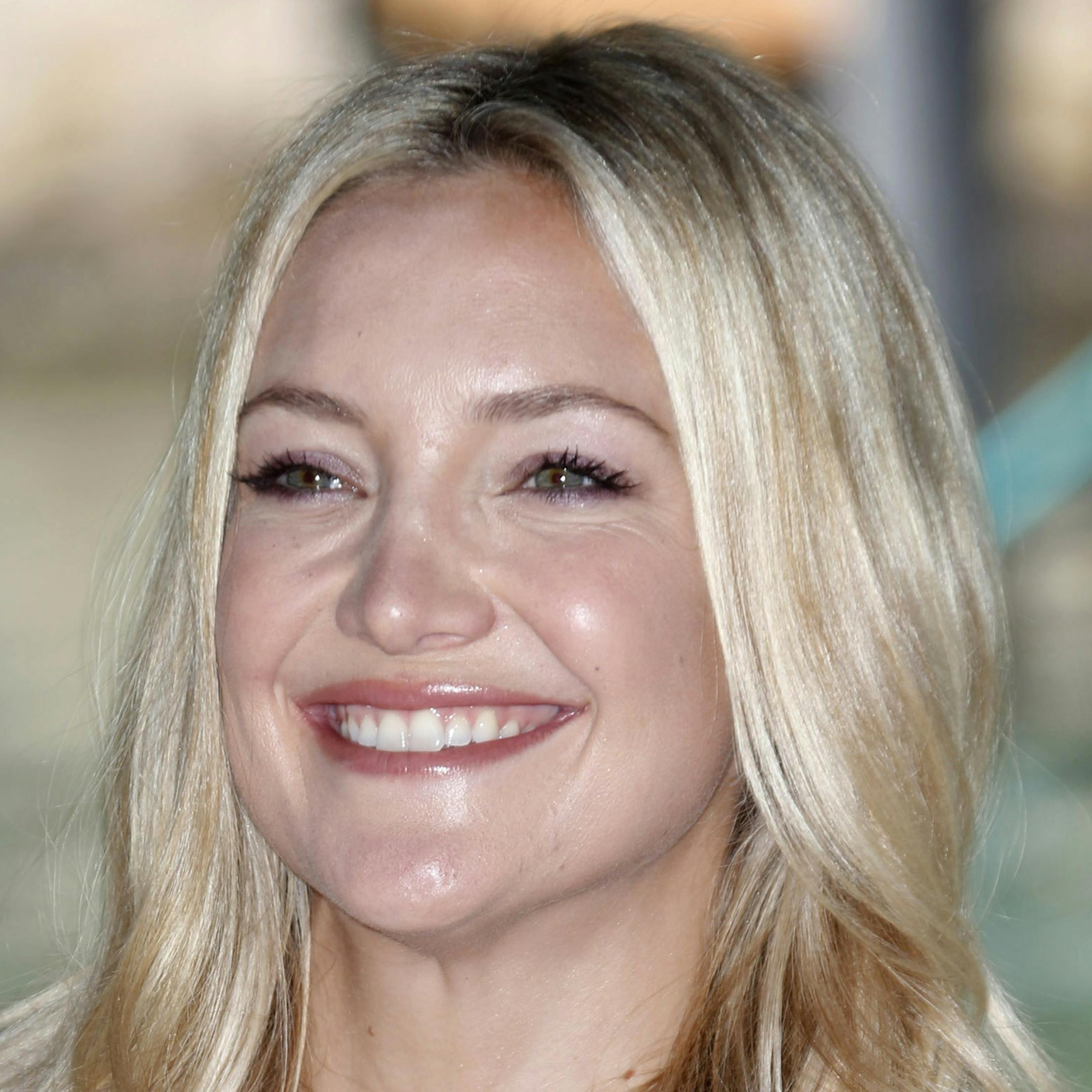 FILE - In this Aug. 29, 2012 file photo, actress Kate Hudson poses for photographers as she arrives for the news conference in Venice, Italy. Hudson says the pressure of stepping out of the shadow of her movie star mom Goldie Hawn was discouraging and daunting. She advised girls to take a chance on their own talent and take risks as they choose a career path. Hudson spoke at the ANNpower Leadership Forum, a week-long program that unites teens from across the country with women leaders in busines