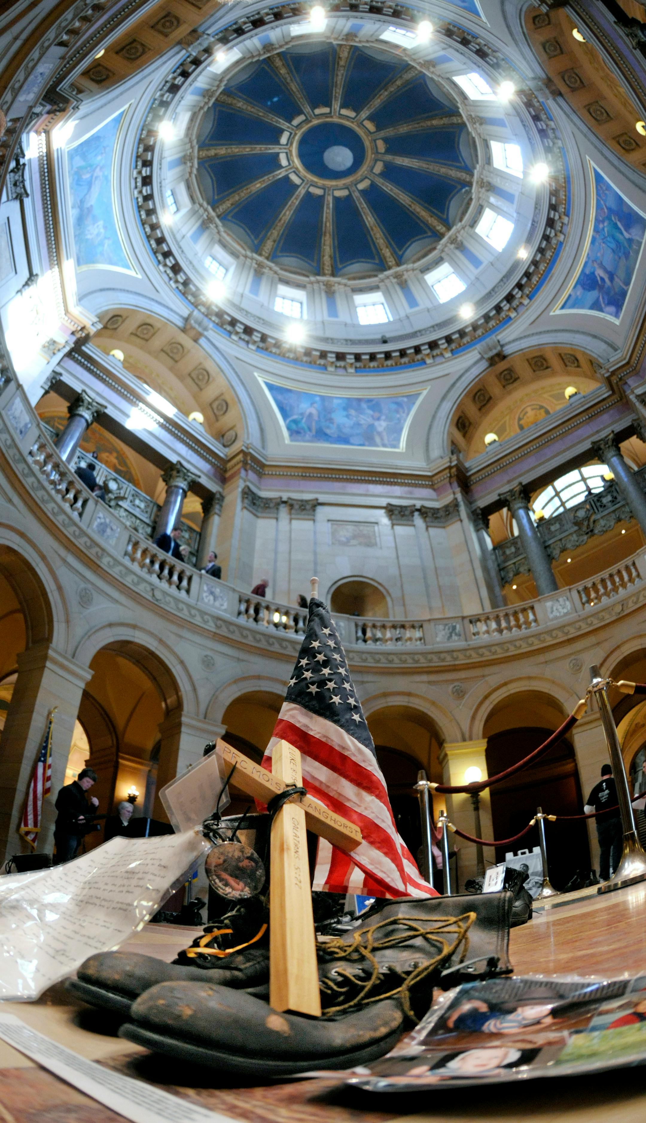 The boots representing Marine Pfc. Moises A. Langhorst of Moose Lake, killed April, 5, 2004, and 58 other pairs of boots representing other Minnesota military casualties in Iraq were part of the memorial service at the Minnesota State Capitol Rotunda on Wednesday.