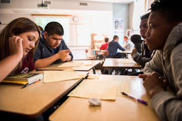 (Left to right) Tenth graders Litzy Amigon, Edwin Santana, Arianna Cyrus and Jayce Harlin review discussion topics at the beginning of their English c