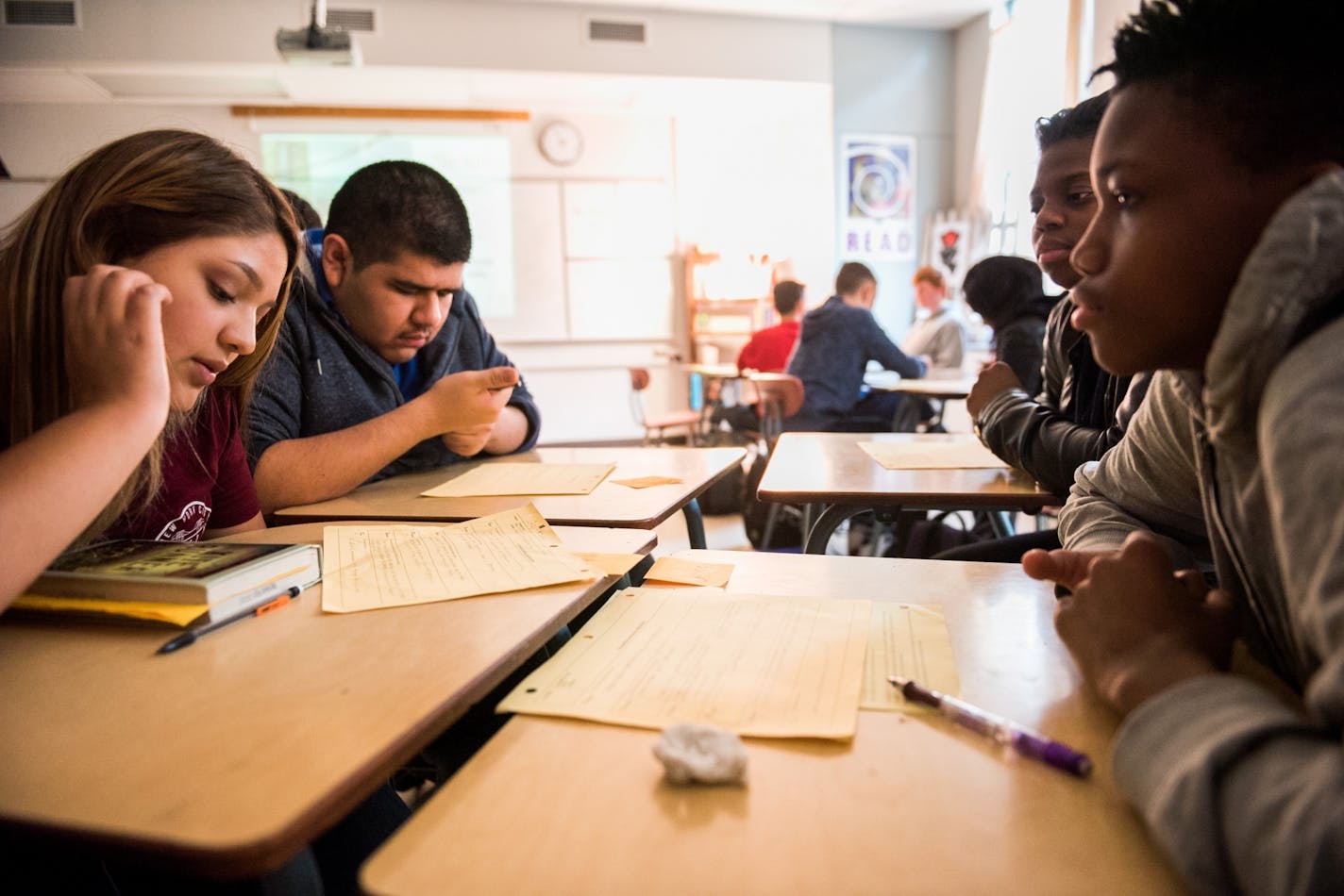 (Left to right) Tenth graders Litzy Amigon, Edwin Santana, Arianna Cyrus and Jayce Harlin review discussion topics at the beginning of their English class.