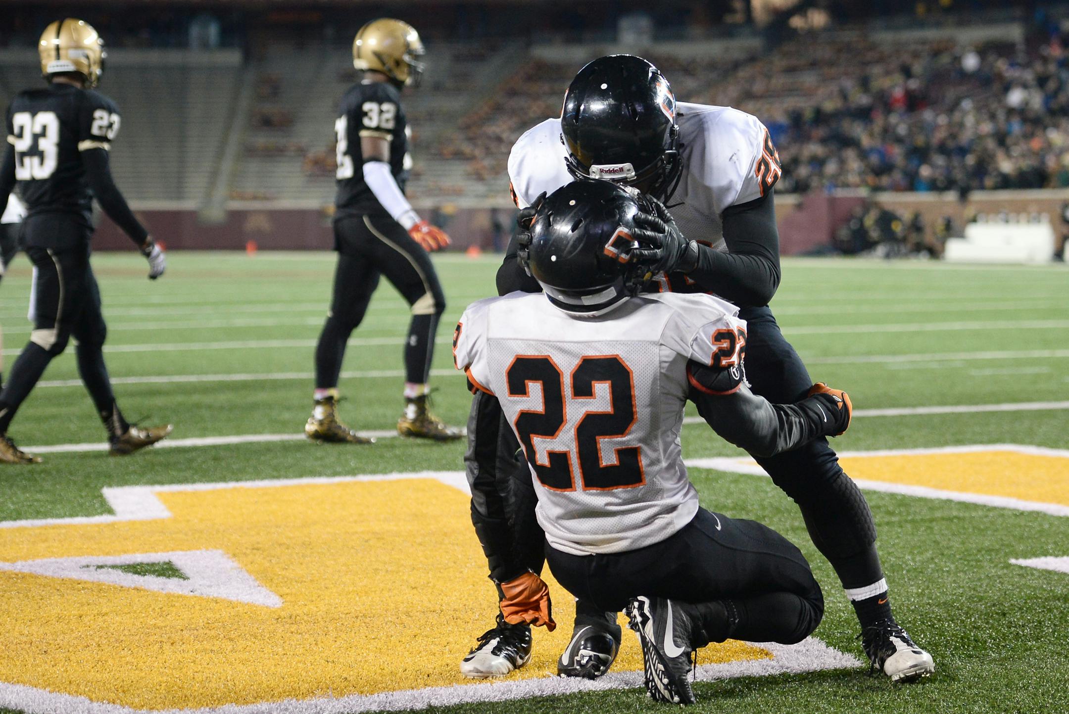 Osseo wide receiver Martelius Hughes (28) celebrated with running back Prince Kruah (22) after Kruah's game-tying touchdown with less than a minute left in the fourth quarter. ] (AARON LAVINSKY/STAR TRIBUNE) aaron.lavinsky@startribune.com Osseo played East Ridge in the Class 6A championship game on Friday, Nov. 13, 2015 at TCF Bank Stadium.