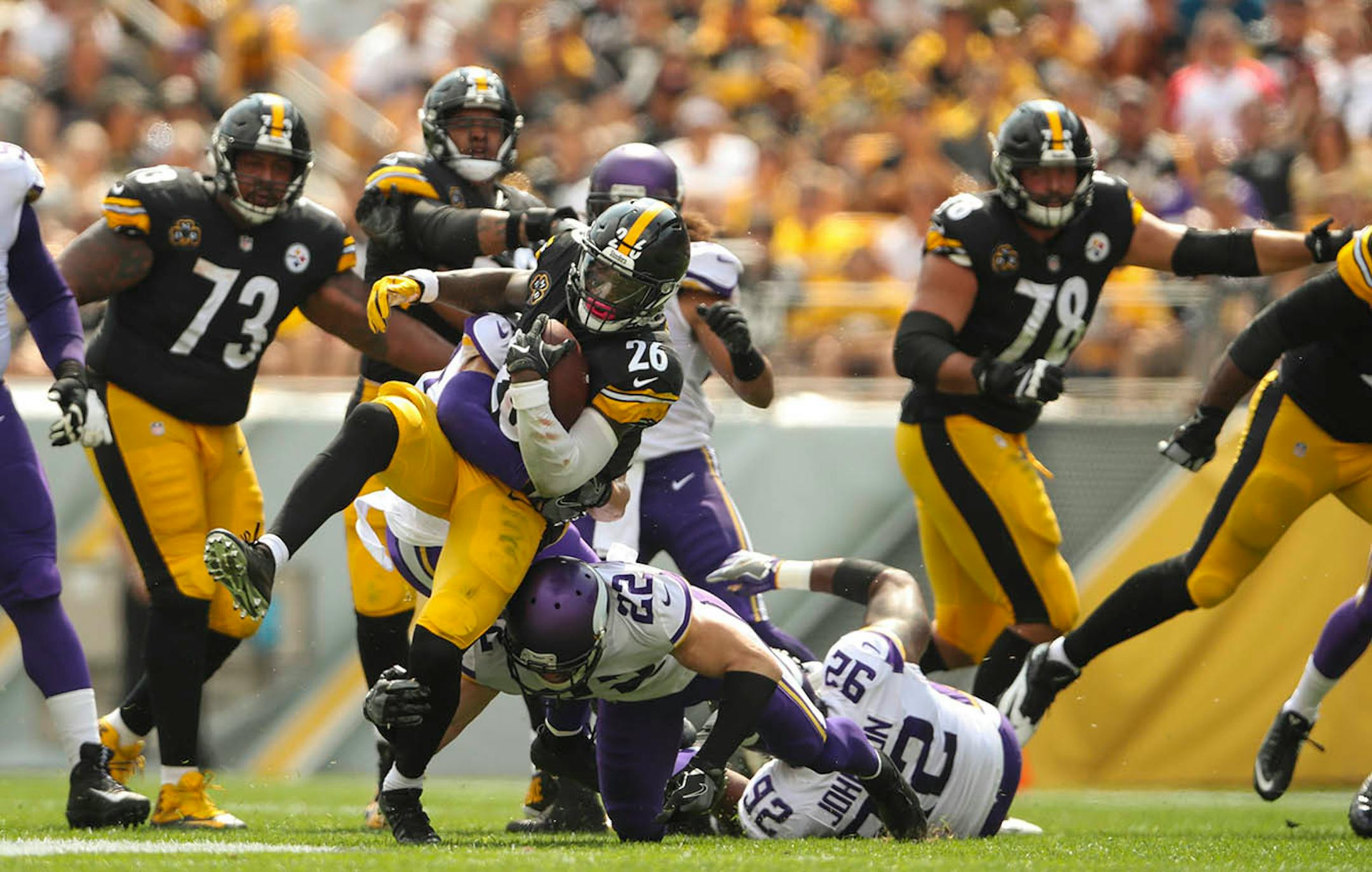 Pittsburgh Steelers running back Le'Veon Bell (26) was tackled by Minnesota Vikings free safety Harrison Smith (22) after gaining nine yards on a first quarter run.