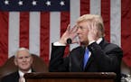 President Donald Trump gestures during his first State of the Union address in the House chamber of the U.S. Capitol to a joint session of Congress Tu