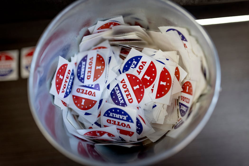 A bucket full of “I voted early” stickers sit near an exit door at the Minneapolis early voting center. 