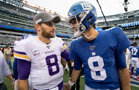 Vikings quarterback Kirk Cousins, left, speaks with Giants quarterback Daniel Jones at the end of a game in 2019.