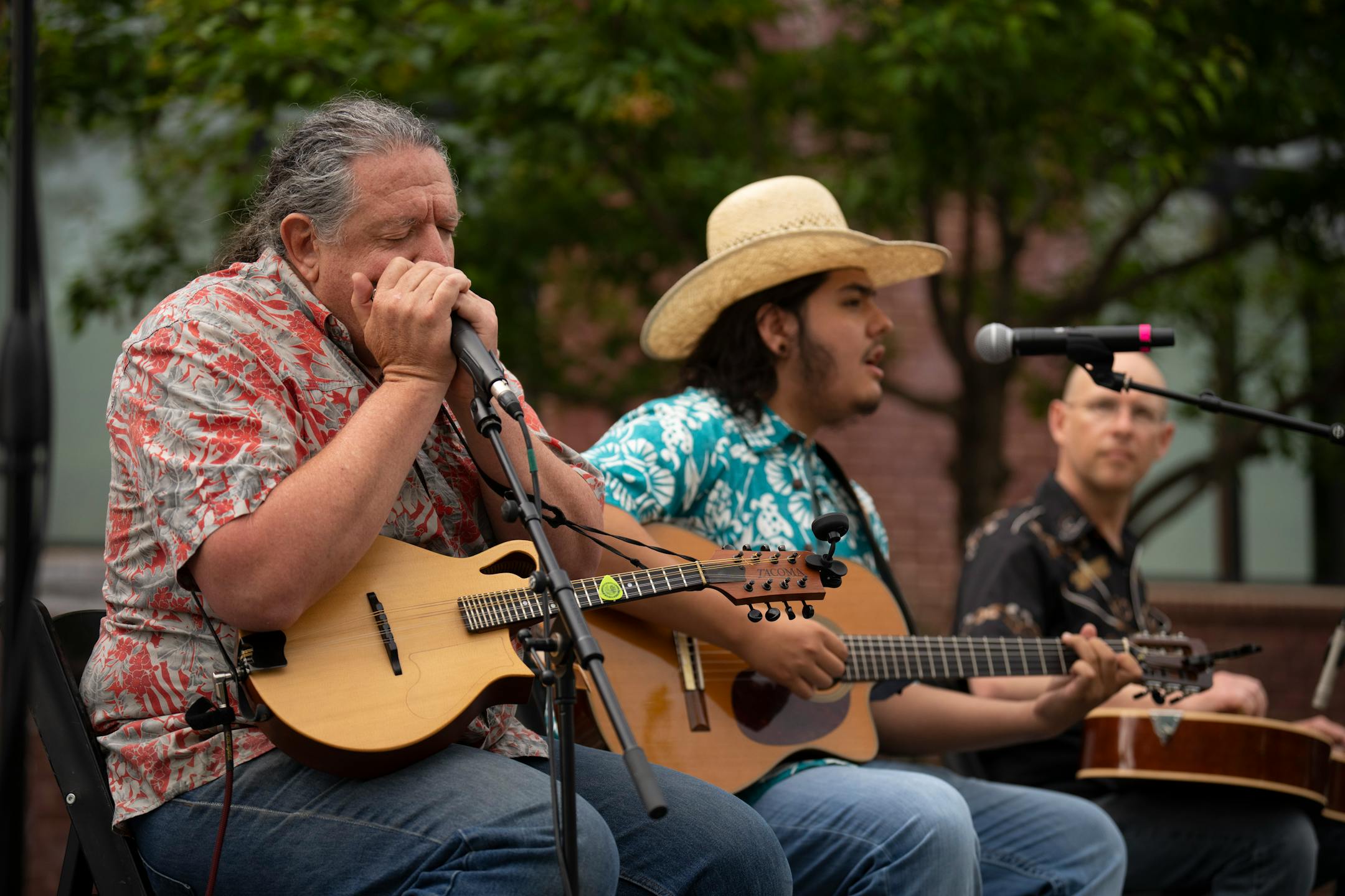 Agalisiga Mackey, with Lyle Deiter, left, and Jared Tyler, right, sang Dylan's "I Shall Be Released" in Cherokee during the program for the opening of the Bob Dylan Center in Tulsa, Okla. on Tuesday, May 10, 2022.