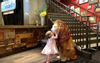 A lion statue greets visitors (including the writer's daughter) in the lobby of Hotel Lincoln, a boutique hotel located in Lincoln Park.