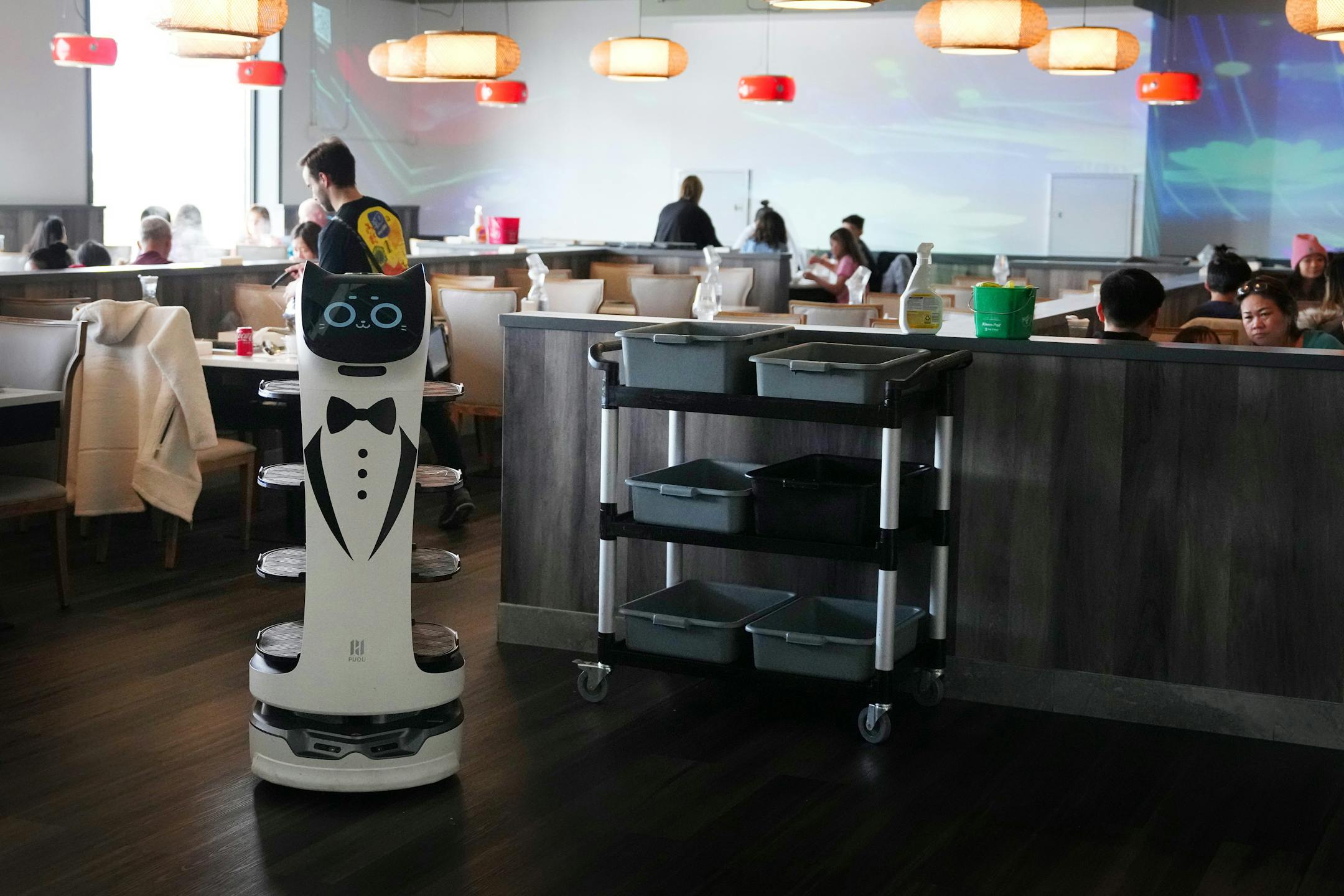A robot waiter returns to the kitchen at Hot Pot City in the new Asia Mall.