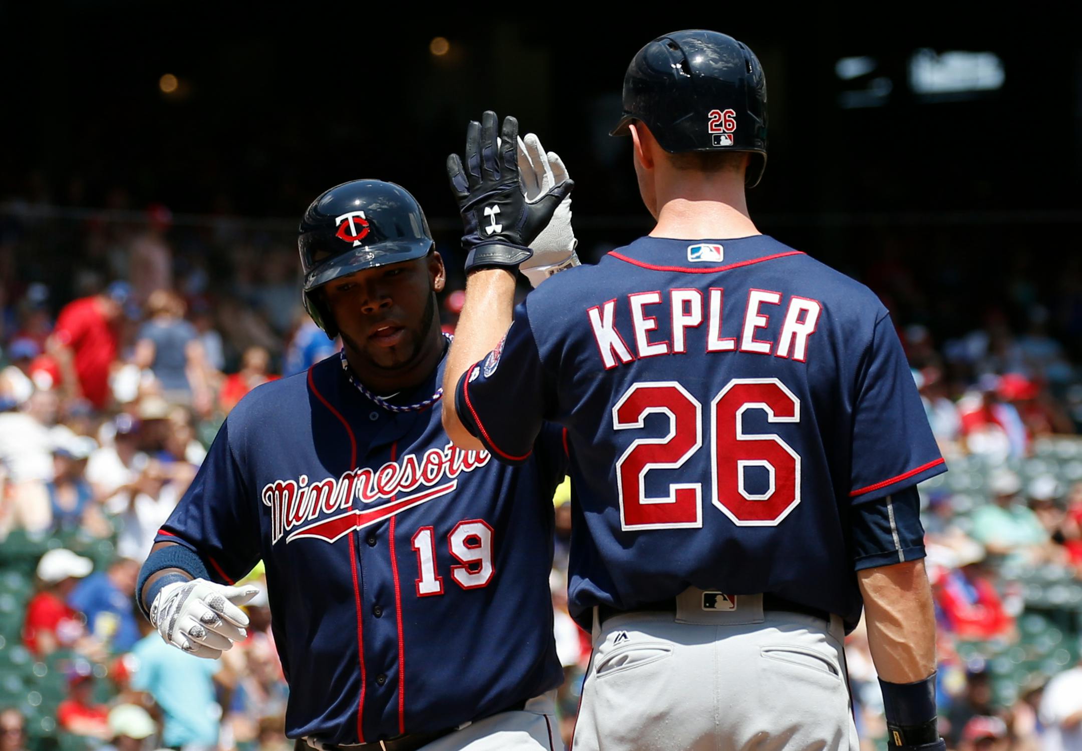 The Twins' Kennys Vargas (19) celebrated his solo home run with Max Kepler during the fourth inning against the Rangers on Sunday.