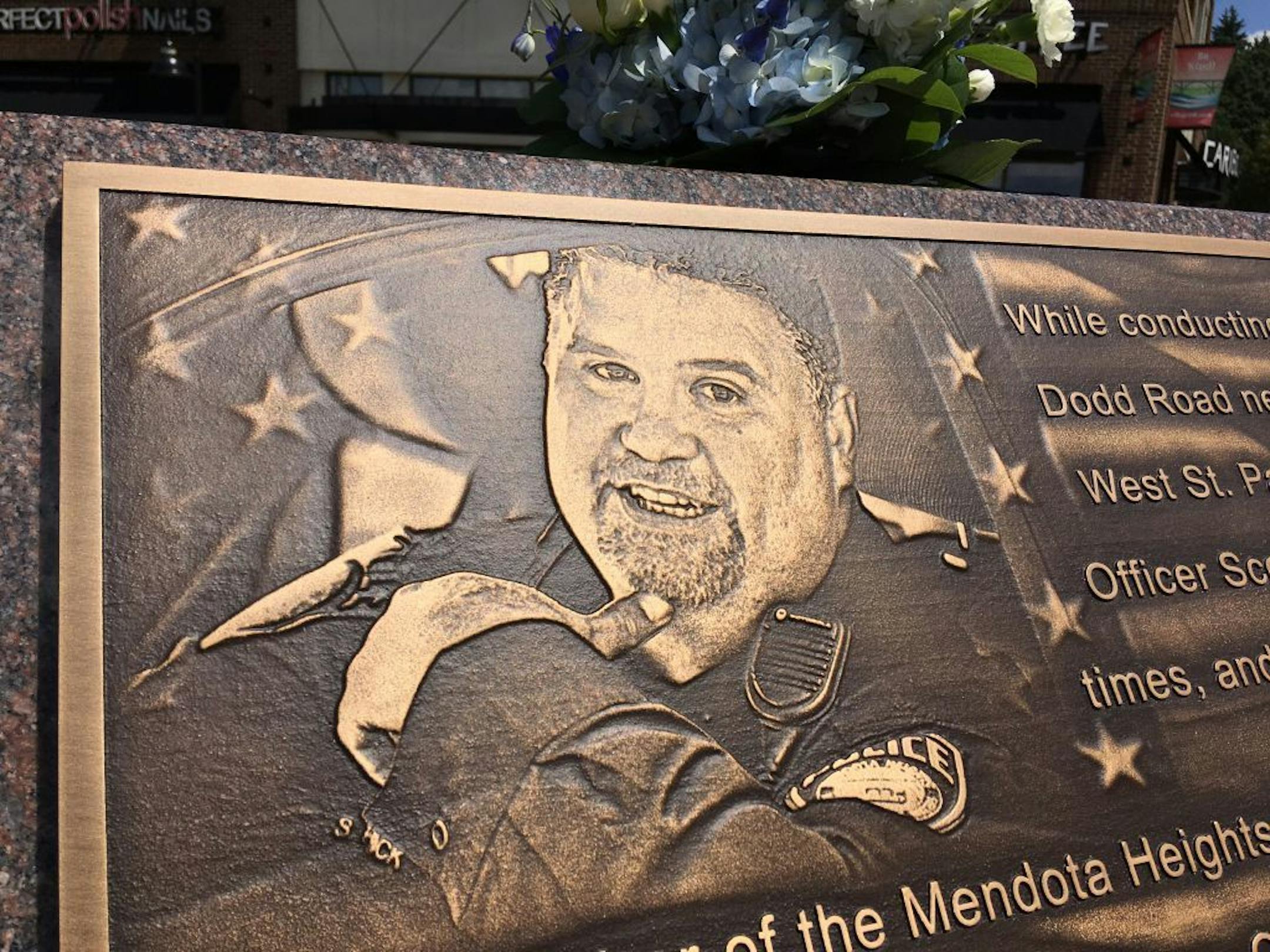 A close-up of the picture of slain Mendota Heights police officer Scott Patrick that is etched on his memorial.