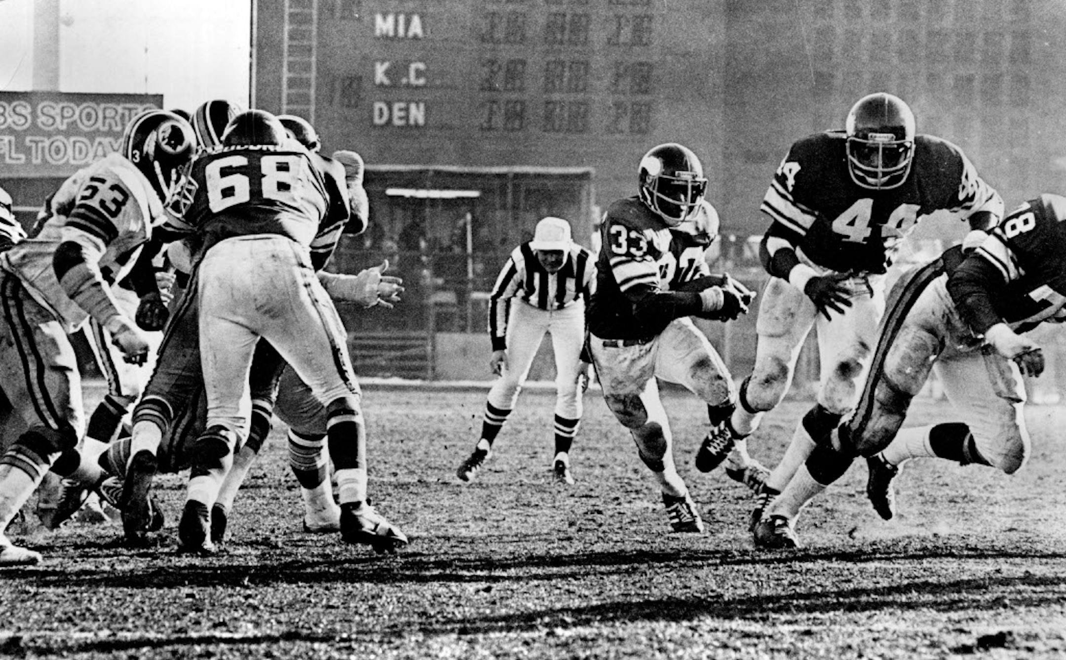 December 19, 1976 Brent McClanahan (33), who rushed for more than 100 yards, started through a gaping hole behind from Charles Goodrum (68), Chuck Foreman (44) and Steve Rilley (78). December 18, 1976 Minneapolis Star Tribune