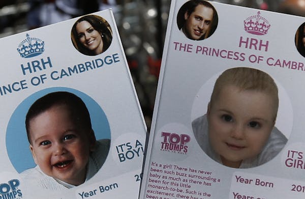 Cards depicting the 'royal baby' either as a boy or a girl, specially made by a games company as a publicity stunt are pictured, backdropped by member