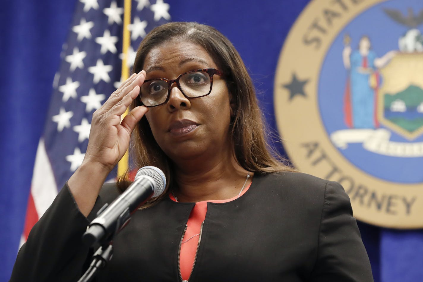 New York State Attorney General Letitia James adjusts her glasses as she announces that the state is suing the National Rifle Association during a press conference, Thursday, Aug. 6, 2020, in New York. James said that the state is seeking to put the powerful gun advocacy organization out of business over allegations that high-ranking executives diverted millions of dollars for lavish personal trips, no-show contracts for associates and other questionable expenditures. (AP Photo/Kathy Willens)