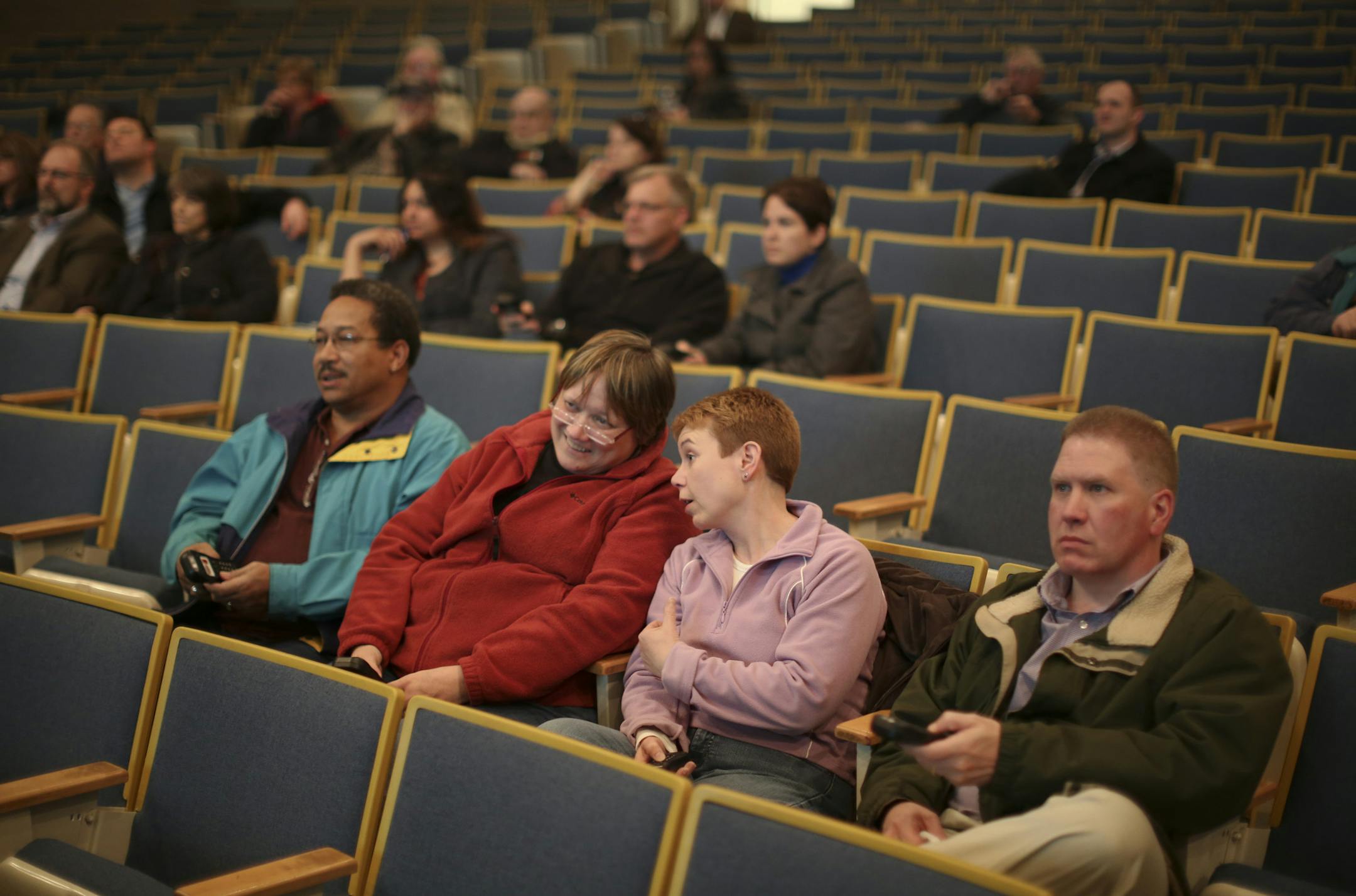 As part of its "Envision Lakeville" process, consultants hired by the city invited people to a series of forums where they can express their opinions on a series of questions about what they want to see in the city's future. Participants used hand held wireless devices to vote on the questions and see real-time results Monday night, March 25, 2013 at Kenwood Trail Middle School. Archie Simmons, Robyn Rose, Jeanne Peterson, and Tim Peterson, from left, were among the 27 Lakeville residents who at