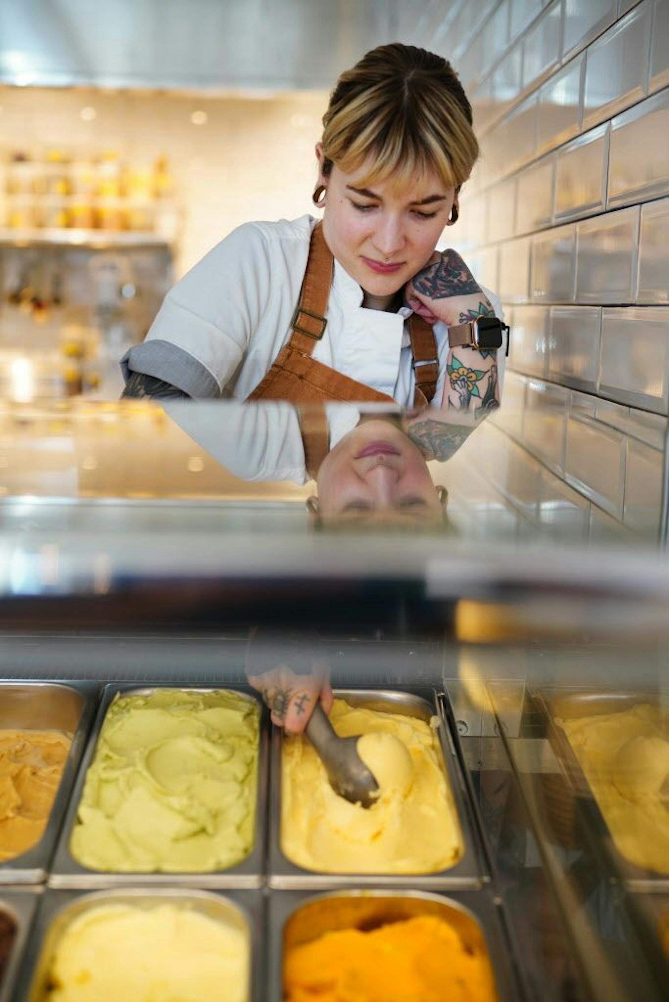 Sous chef Jasmine Weiser scoops up some mandarine allspice sorbet.