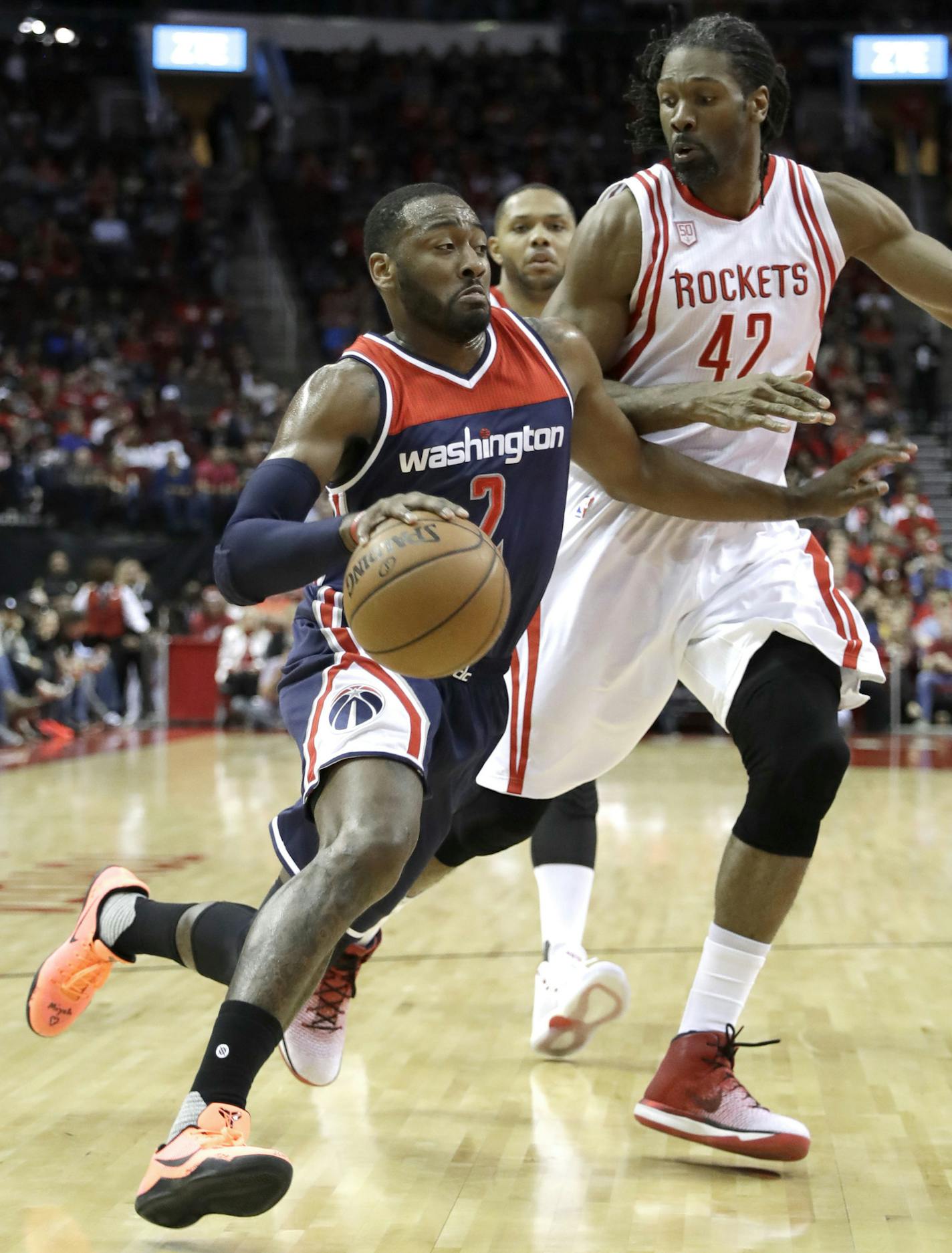 Washington Wizards' John Wall (2) drives toward the basket as Houston Rockets' Nene Hilario (42) defends during the first half of an NBA basketball game Monday, Jan. 2, 2017, in Houston. (AP Photo/David J. Phillip)