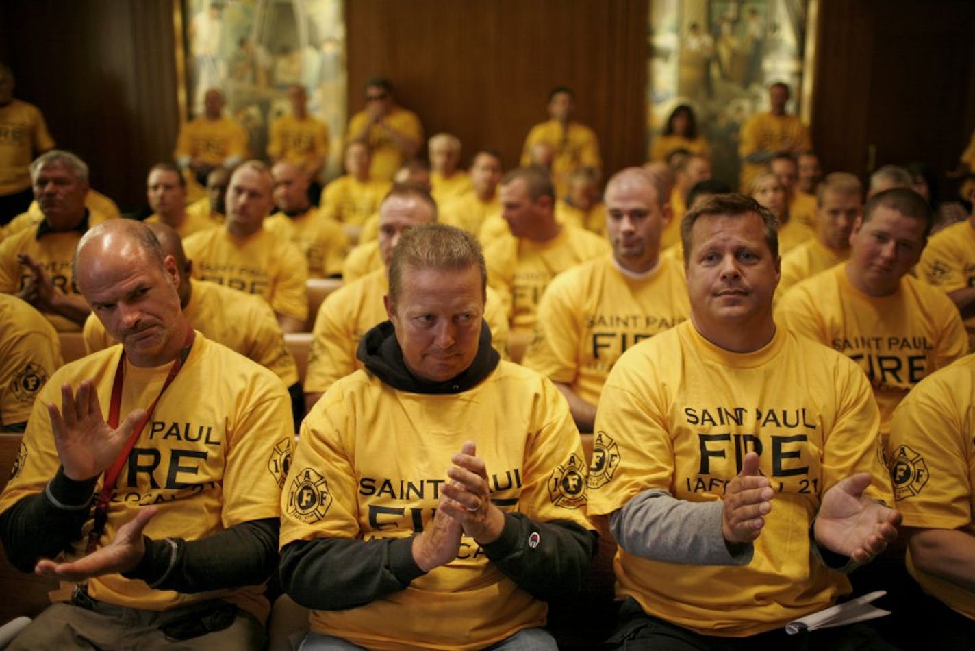 From left, St. Paul firefighters Aaron Shoemaker, Kevin Creamer and John Galle joined their colleagues Wednesday in packing a St. Paul City Council meeting to express their concern over a proposed budget that would cut $1 million from Fire Department spending next year.