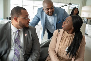 Damon Jenkins (center), the Twin Cities regional market president of First Independence Bank, spoke with Donte Stamps (left) and Charlotte Epee, finan