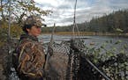 Parker Smith, a Willmar eighth-grader, overlooks a Minnesota River backwater in Renville County on the first day of duck hunting Saturday. Hunting gen