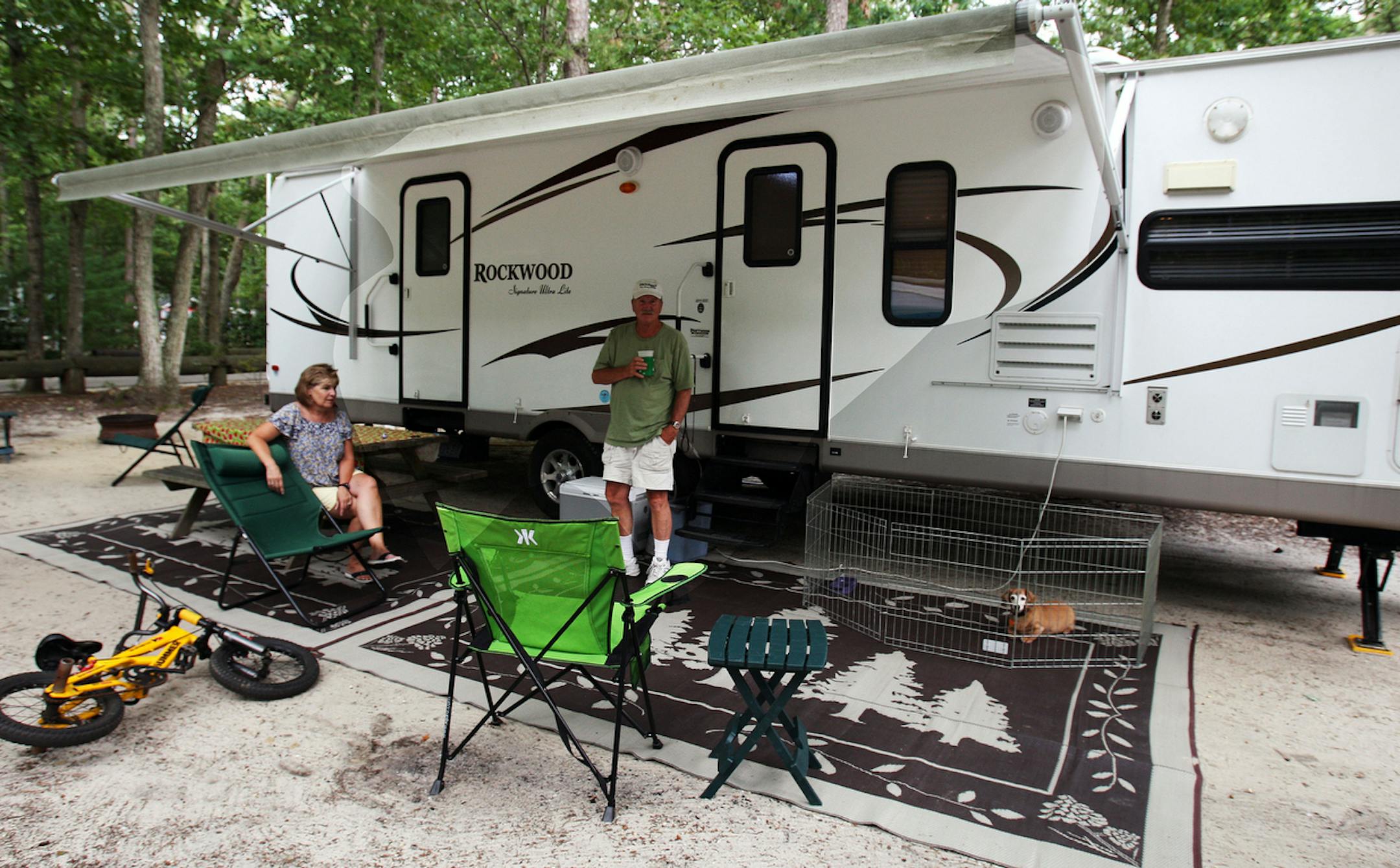 Janet and Carl Reeves, of Millville, NJ, enjoy camping in their recreational vehicle at the Whippoorwill Campground, in Marmora, NJ, Wednesday, Aug. 15, 2012. High gas prices have forced many RV owners to take a camping vacation closer to home. (AP Photo/Press of Atlantic City, Dale Gerhard)