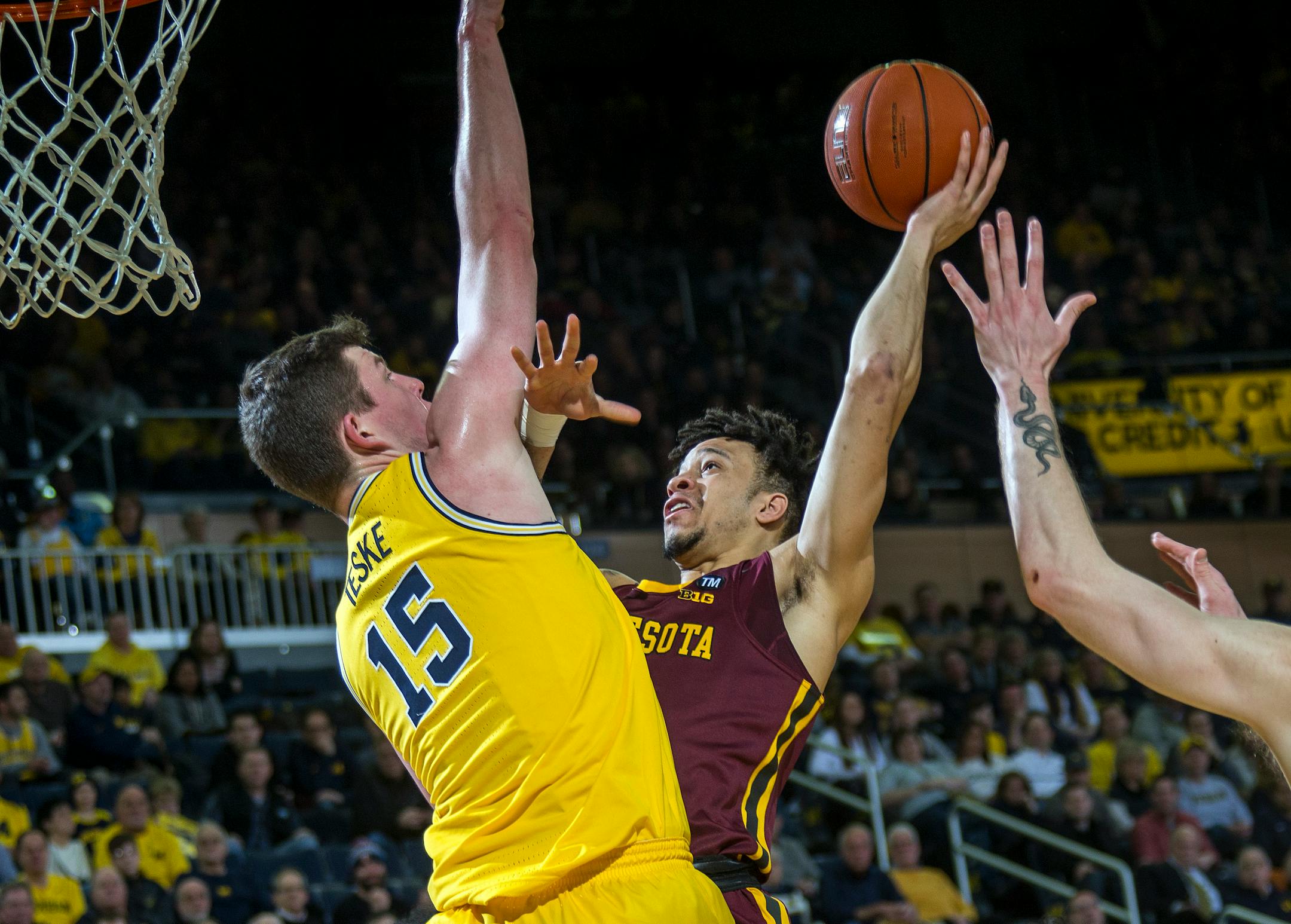 Michigan center Jon Teske defended a shot attempt from Gophers guard Amir Coffey in January.