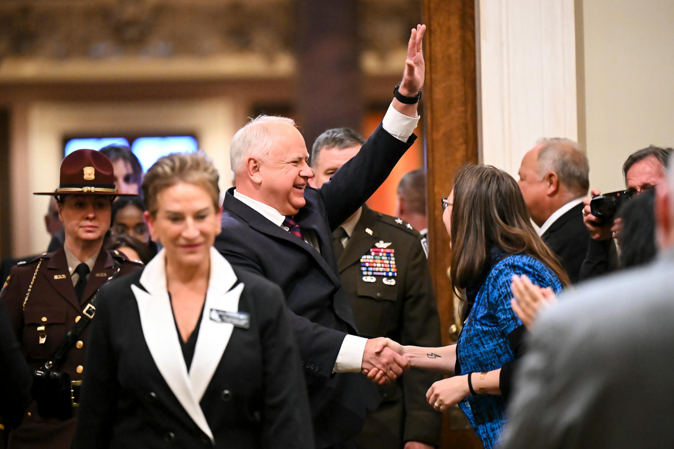 Minnesota Gov. Tim Walz is welcomed into the house chambers before delivering the State of the State address.