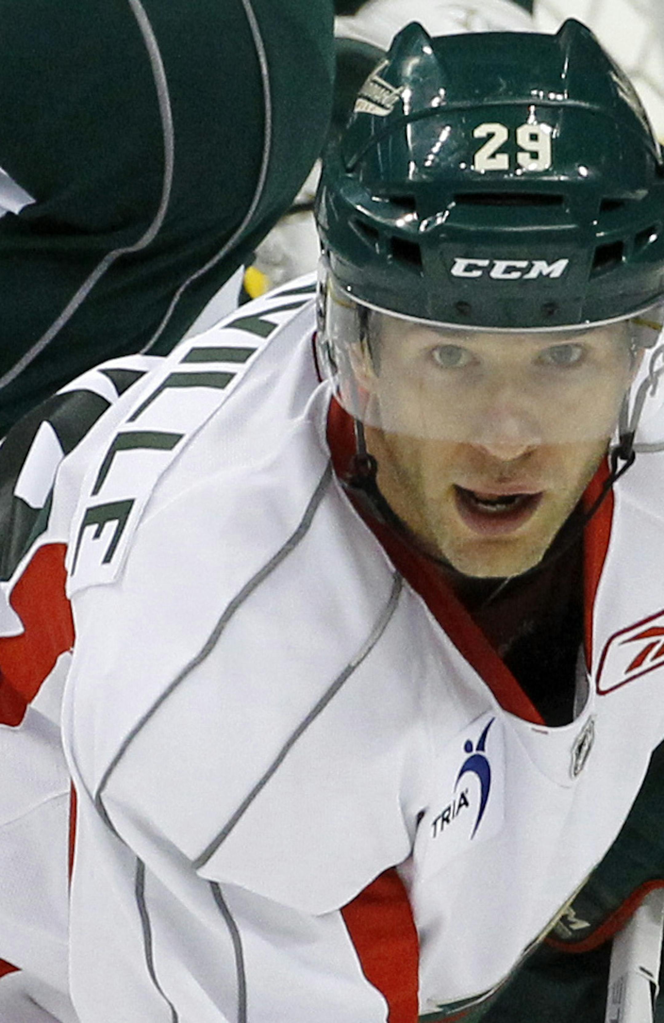 Minnesota Wild center Mikko Koivu, center, of Finland, takes part in a scrimmage during NHL hockey training camp in St. Paul, Minn., Friday, Sept. 18, 2015. At bottom is teammate Jason Pominville. (AP Photo/Ann Heisenfelt)