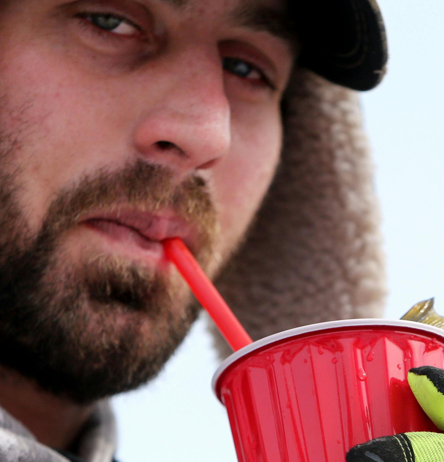 With a perch in a cup, Brandon Knock of Zimmerman uses a straw to aerate the water while waiting to register his fish on Hole in the Day Bay of Gull Lake during the Ice Fishing Extravaganza Saturday, Feb. 6, 2016, in Brainerd, MN.](DAVID JOLES/STARTRIBUNE)djoles@startribune.com About 10,000 ice fishing contestants were expected to headed to Gull Lake north of Brainerd for the Brainerd Jaycees 26th Annual $150,000 Ice Fishing Extravaganza. **Brandon Knock,cq