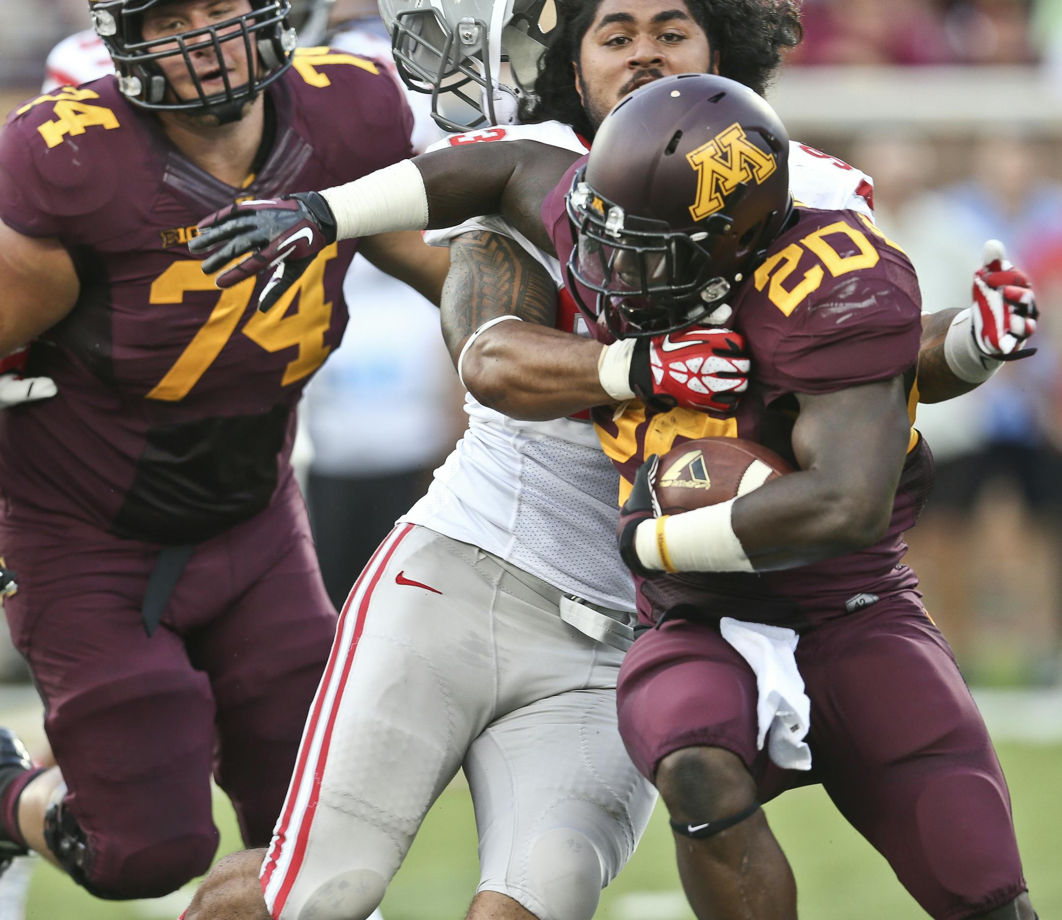 UNLV Rebels defensive lineman Sonny Sanitoa (93) dragged Minnesota Golden Gophers running back Donnell Kirkwood (20) back for a four yard loss on the play in the second quarter during the Minnesota Gophers vs. UNLV in the season opener at TCF Bank Stadium at the University of Minnesota in Minneapolis, Minn., on Thursday, August 29, 2013. ] (RENEE JONES SCHNEIDER • reneejones@startribune.com)