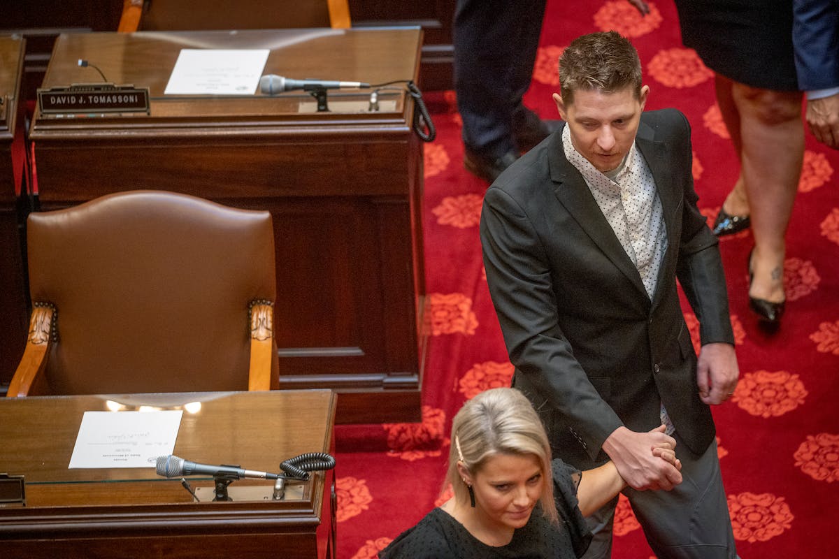 Waseca officer Arik Matson, was guided his wife Megan Matson, as they made their way to the Senate chambers to be recognized by the Senate, Tuesday, J
