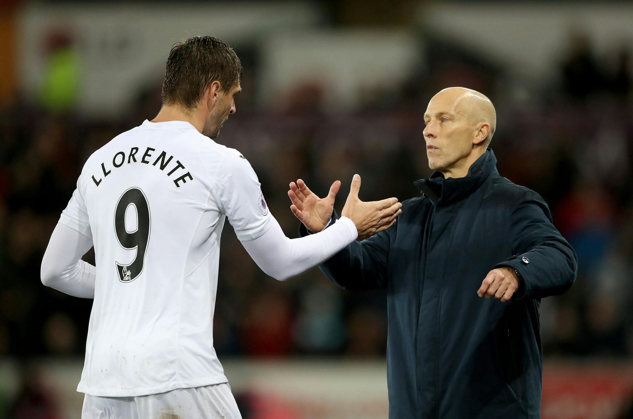 Swansea City's Fernando Llorente, left, with Swansea City manager Bob Bradley as he is substituted off during the English Premier League soccer match between Swansea City and Sunderland at the Liberty stadium in Swansea Wales. Saturday, Dec, 10, 2016. (Nick Potts/PA via AP)