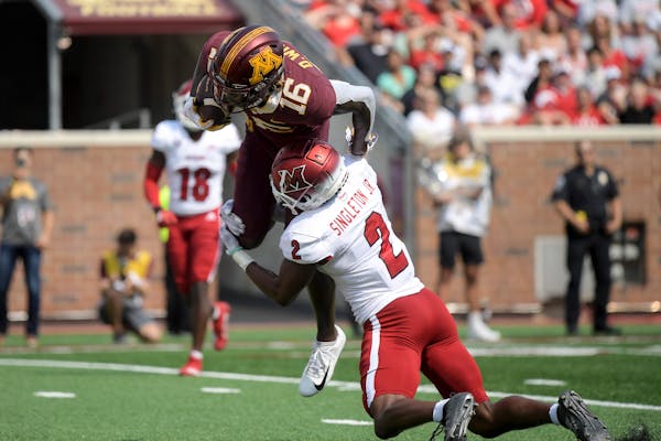 Minnesota Gophers wide receiver Dylan Wright (16) leapt into the endzone for a touchdown as he was tackled by Miami (Oh) Redhawks defensive back Cecil