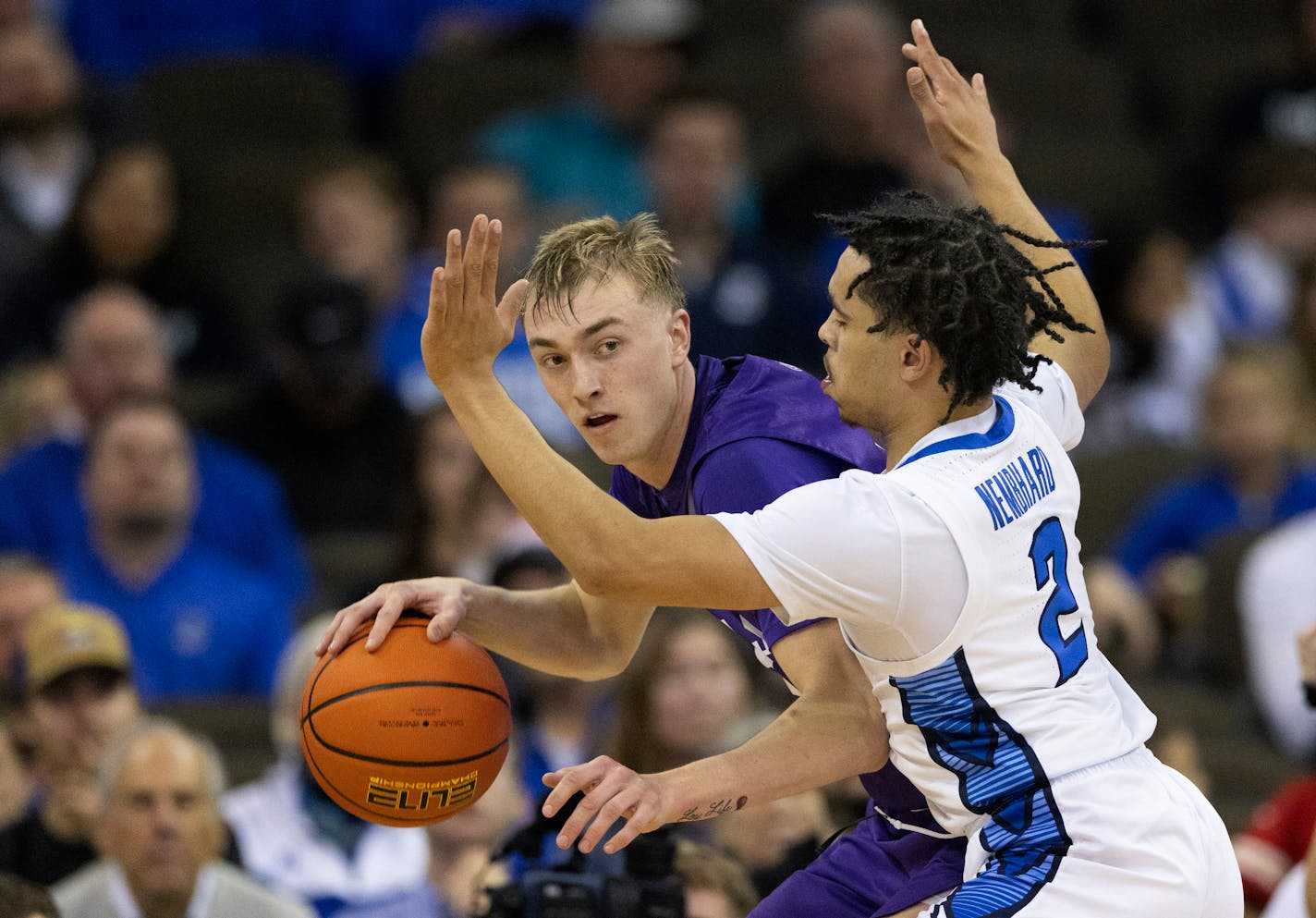 St. Thomas' Andrew Rohde, left, drives against Creighton's Ryan Nembhard (2) during the first half of an NCAA college basketball game on Monday, Nov. 7, 2022, in Omaha, Neb. Rohde scored 15 points against Creighton. (AP Photo/Rebecca S. Gratz)