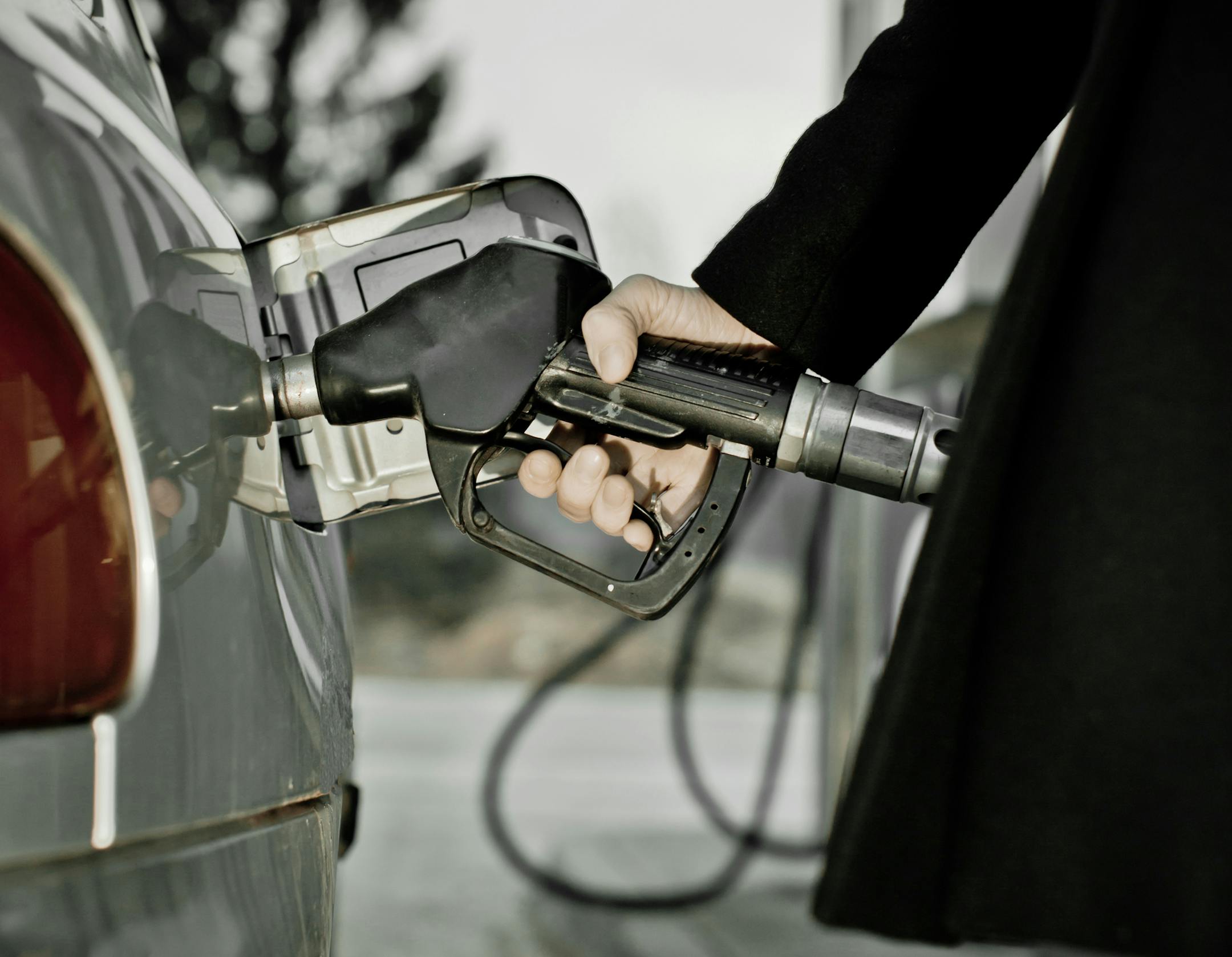 Detail of a woman at the gas station - selective focus, vintage toning
