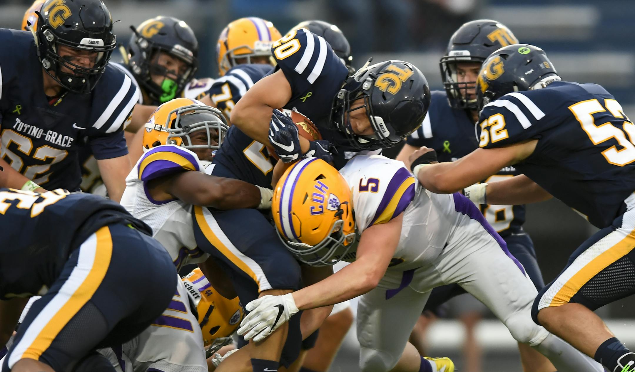 Totino-Grace halfback Gabe Vosen (20) was tackled by a host os Cretin-Derham Hall defenders in the first half. ] AARON LAVINSKY &#xa5; aaron.lavinsky@startribune.com Totino-Grace played Cretin-Derham Hall in a Class 6A football game on Thursday, Aug. 30, 2018 at Totino-Grace High School in Fridley, Minn.
