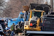 Minneapolis city crews worked Tuesday to clear a homeless encampment during rush hour along 5th Avenue near Lake Street in Minneapolis. Traffic in the
