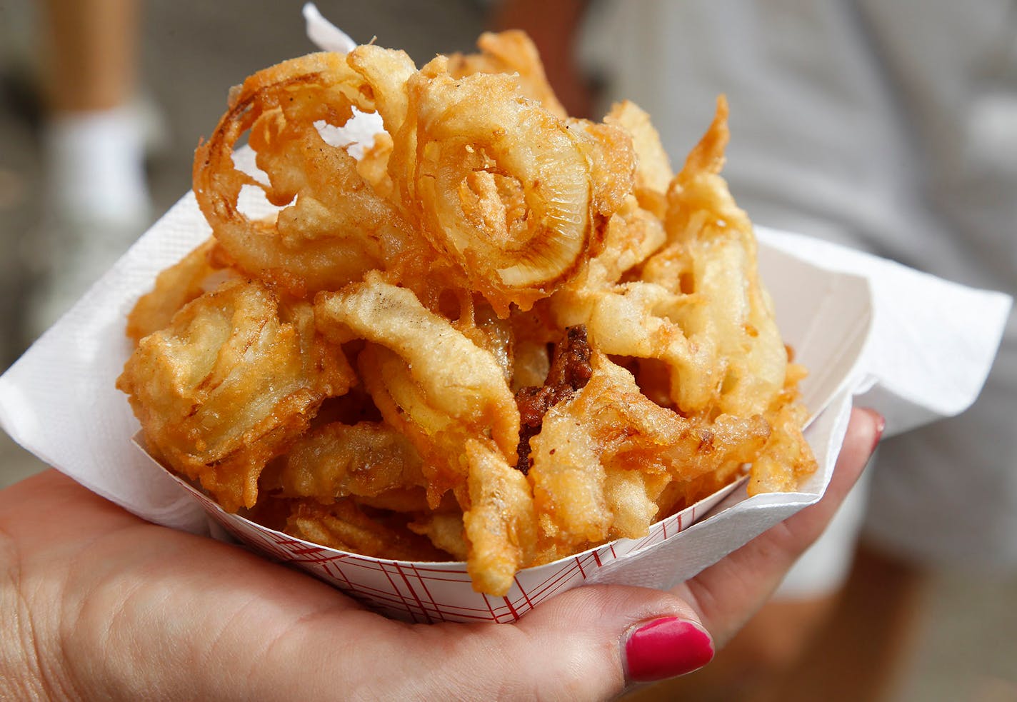 Danielson's & Daughters
That I don't file onion rings under "battered-and-deep-fried" is indicative of my general head-in-the-sand dietary views during the fair's 12-day run. The house specialty ($6) from this 61-year-old fair fixture is nothing more than juicy, fresh-cut yellow onions that are dipped in a light, pancake-like batter and expertly fried in simmering vegetable oil. There's a delicate crunch to the coating and a soft, quietly sweet bite to the onions. Shareable, not that any sane pe