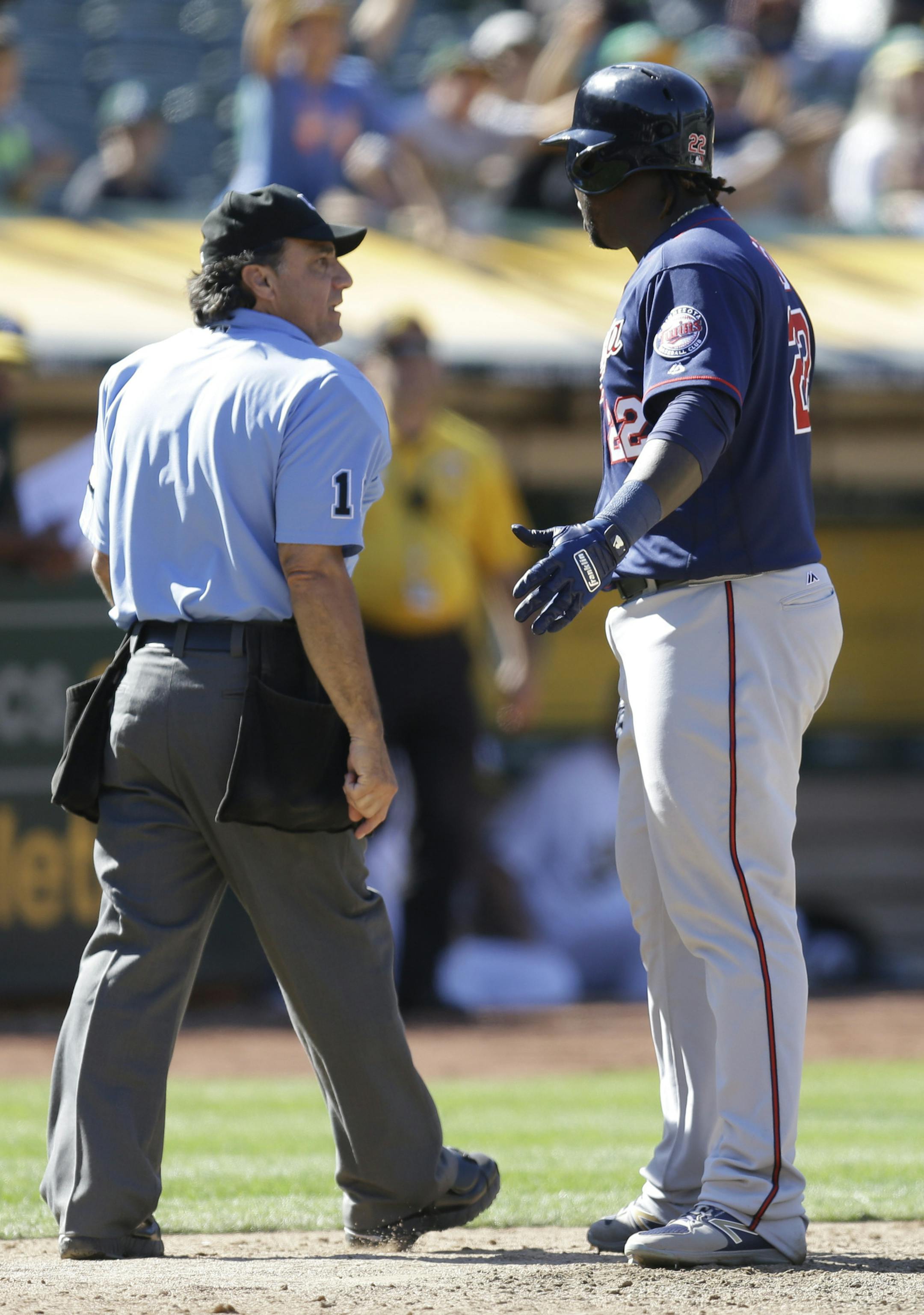 Minnesota Twins' Miguel Sano, right, argues after being ejected by home plate umpire Phil Cuzzi, left, in the eleventh inning of a baseball game against the Oakland Athletics, Sunday, July 30, 2017, in Oakland, Calif. (AP Photo/Ben Margot)