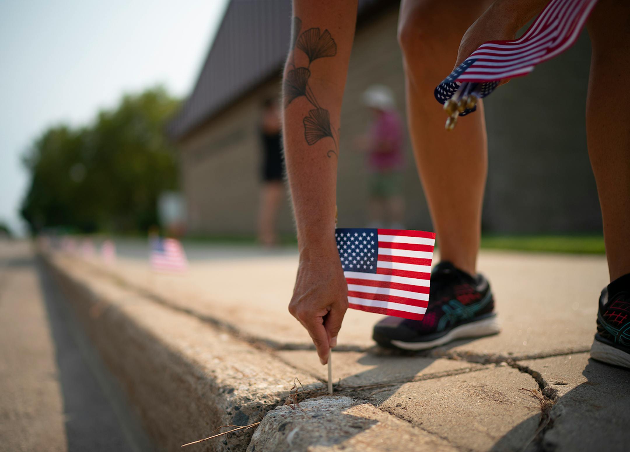 Rachel Rigenhagen, the founder of the Appleton Community Diversity Coalition (ACDC) Facebook group, arrived early to place flags along West Schlieman Ave. outside the City Offices before the weekly demonstration.