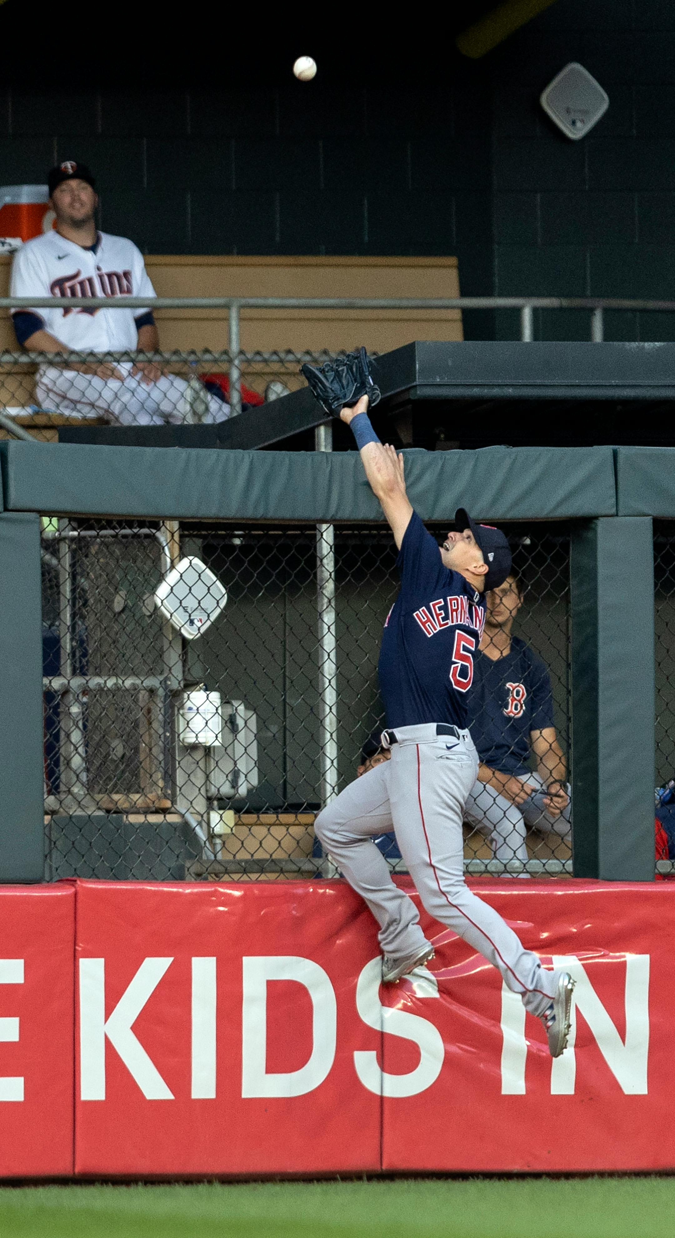Boston Red Sox centerfielder Kike Hernandez (5) can't reach a home run by Jake Cave of the Minnesota Twins in the second inning.