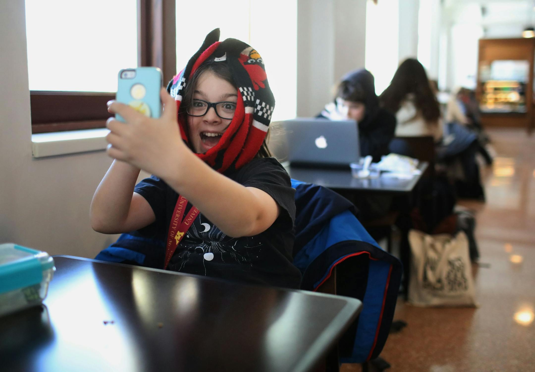 Elliott Tanner, 11, a junior at the University of Minnesota, takes a selfie in the Surdyk's Café in Northrup Auditorium where he was having lunch with him mom.