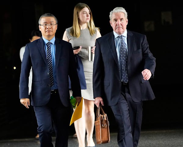 Former Minneapolis police officer Tou Thao, left, and his attorney Robert Paule arrive for sentencing for violating George Floyd’s civil rights outs