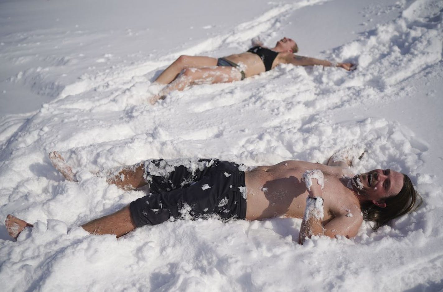 Mark McKee and Ingrid Aune were ready to cool down after baking in the 200 degree heat of Nickolai Koivunen's MinneSauna on the ice of Lake Harriet as part of the Art Shanty Project Sunday morning.