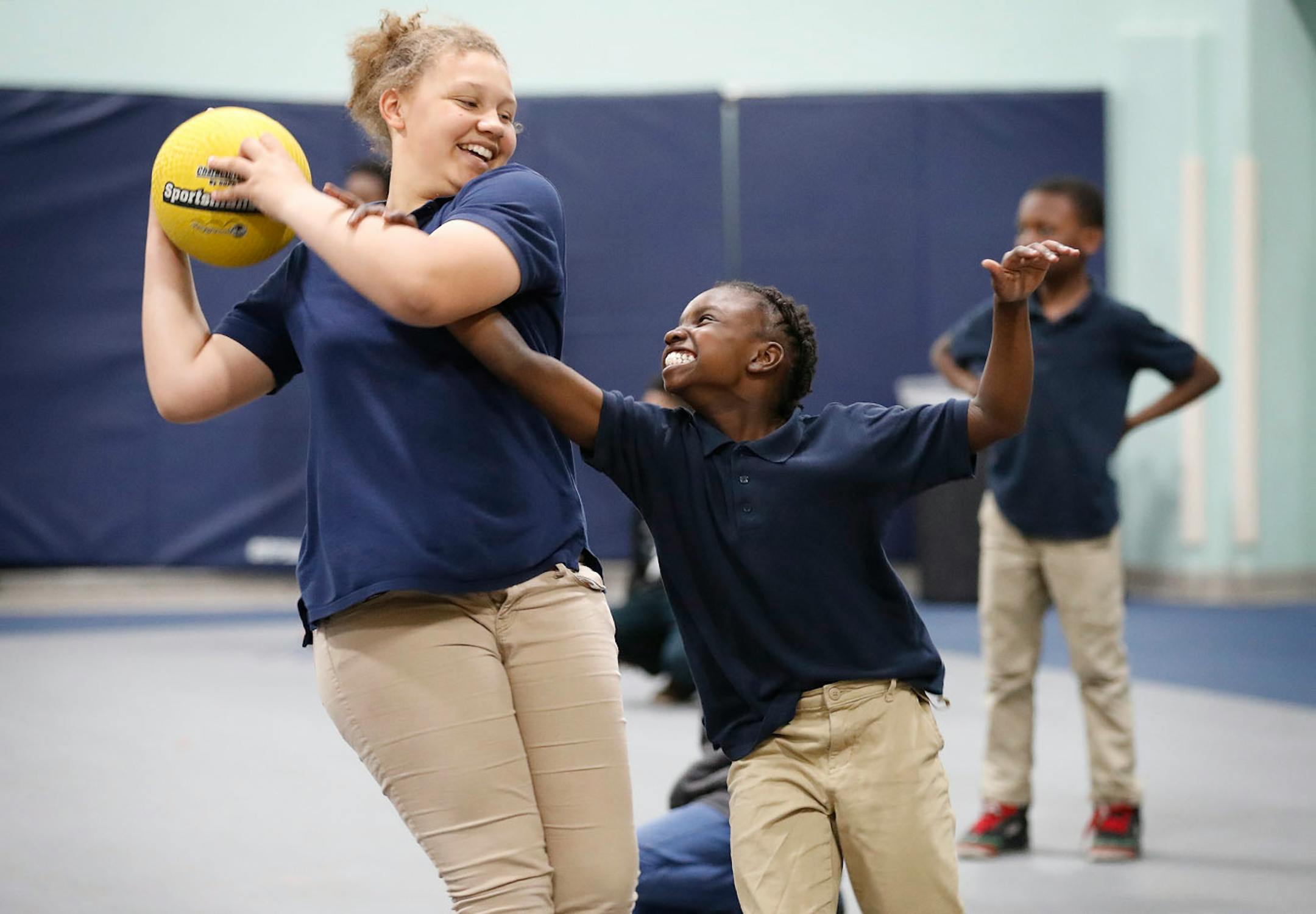 Essence Bell-Williams, left, 10, keeps the ball away from Helena Wheeler, 10, during gym time.