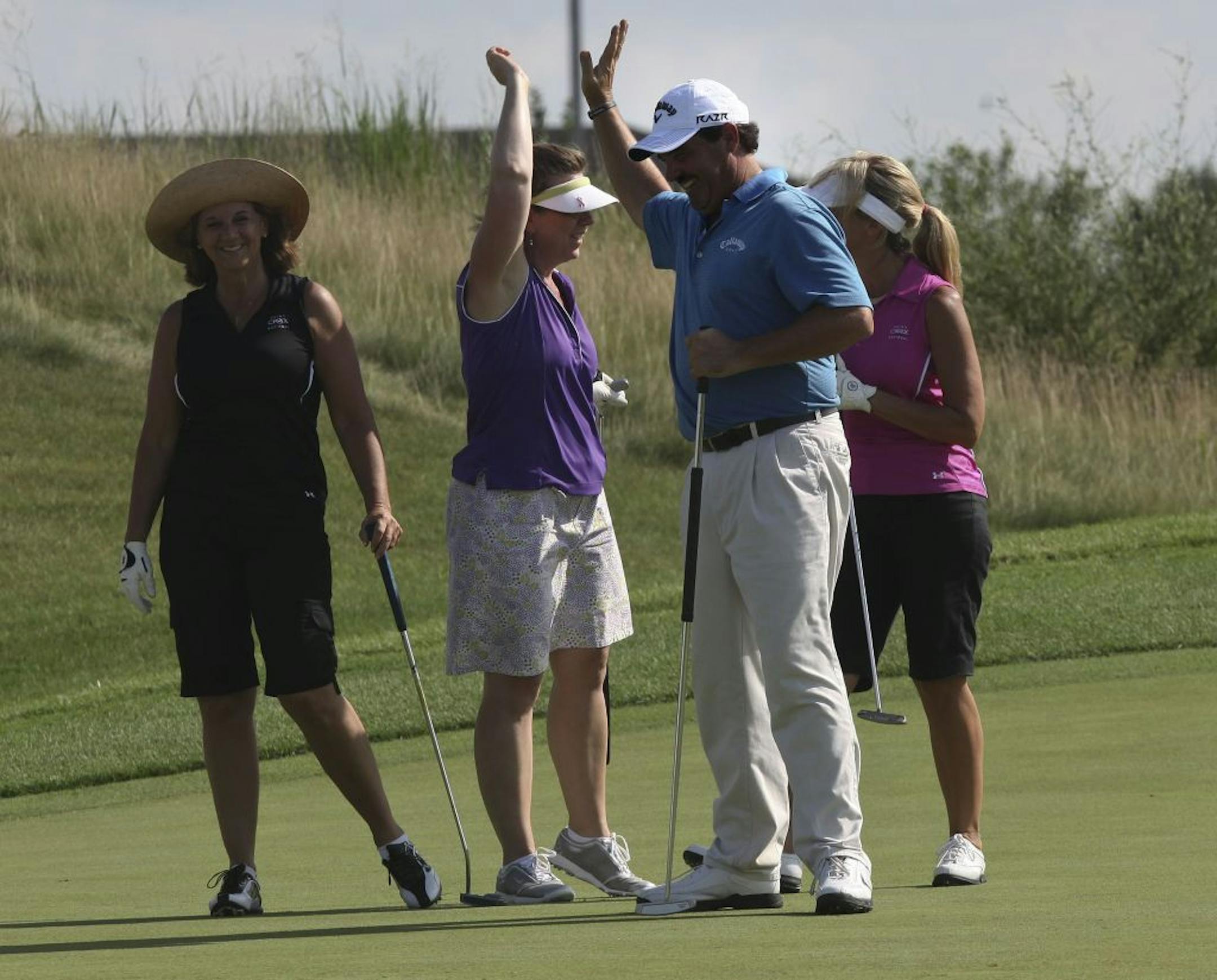 Ben Bates celebrated with his group after making a putt during a 3M Championship pro-am Tuesday. Bates, a longtime Nationwide Tour player, turned 50 in June and is playing on a sponsor's exemption.